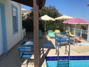 a group of chairs and umbrellas next to a pool at Breathtaking sea and Mountain views with Private pool, Peace full relaxing Villa with WiFi near Shops and Restaurants in Chania