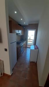 a kitchen with a white refrigerator and a tile floor at Apparemment de luxury in Chozas +14 photos