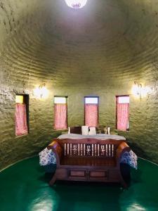a bedroom with a large bed in a stone room at สวนตุ๊ข้าว(SuanThuKhaw) in Ban Mae Cho