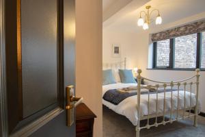 1 dormitorio con 1 cama junto a una ventana en Former 16th Century Inn - In the heart of Macclesfield, gateway to the Peaks, en Macclesfield