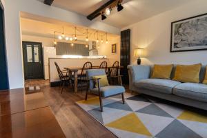 a living room with a couch and a table at Former 16th Century Inn - In the heart of Macclesfield, gateway to the Peaks in Macclesfield