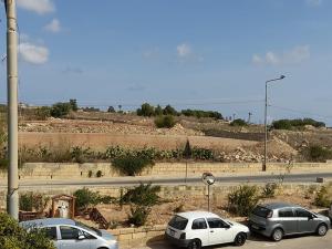 a group of cars parked in a parking lot at Dynesty B&B in Birżebbuġa