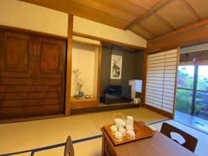 a living room with a table and a television at 金閣京都 in Kyoto