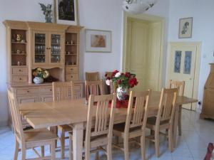 a dining room with a wooden table and chairs at Pension Phönix in Sighişoara