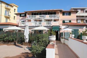 a view of a building with an umbrella and plants at Del Prado in Riva Ligure