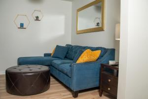 a blue couch in a living room with a mirror at True North - A Beach & Boat Lover's Dream in Carolina Beach