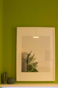 a picture of a plant in a green wall at Intendente 1865 in Lisbon