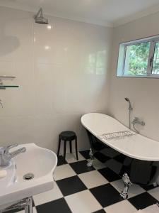 a bathroom with a bath tub and a sink at La Verdure Fruit Farm in Franschhoek