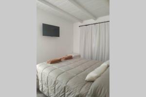 מיטה או מיטות בחדר ב-Casa de Playa en el Bosque