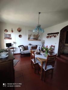 a kitchen and living room with a table and chairs at Il Piccolo Giardino in Perinaldo