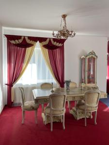 a dining room with a table and chairs at Pool Villa with japanese garden in Kaunas