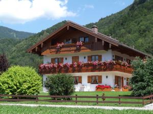 a large house with flowers on the balcony at Haus Wiesenblick in Oberwössen