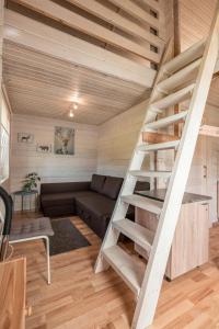 a living room with a staircase in a tiny house at Дом LBerry Брусника у Ладоги in Sortavala