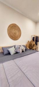 a bed with blue sheets and pillows in a room at Summerfield Homestay and Cafe in Pacitan