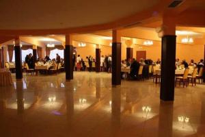 a restaurant with tables and people sitting at tables at OKRĄGLAK Residence Sosnowiec in Sosnowiec
