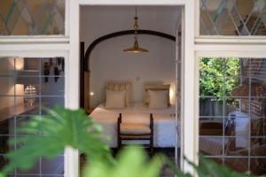 a bedroom with a bed with a chair and a window at Vakantiewoning Guesthouse MOMO in Dilsen-Stokkem