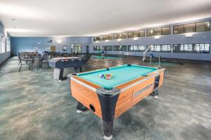 a large room with a pool table in it at AmericInn by Wyndham Green Bay Near Stadium in Green Bay