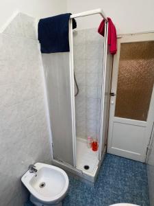 a bathroom with a shower with a toilet and a sink at Appartamento Low-cost Fillak in Genoa