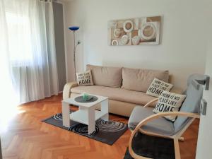 a living room with a couch and a table at Bright & Cozy Pula in Pula