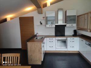 a kitchen with white cabinets and a sink at Leitingerhof in Virgen