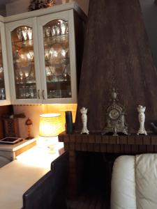 a bedroom with a bed and a clock on a table at Mandy's cosy luxury flat in Piraeus