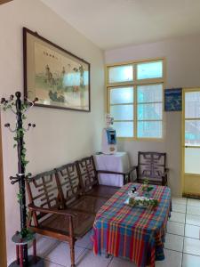 a dining room with a table and two chairs and a table at Guan Ma Homestay in Miaoli
