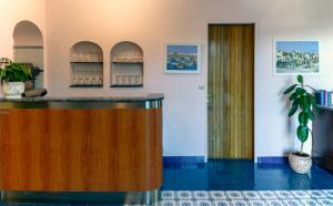 a bar in a room with a potted plant at Hotel Bellavista in Anacapri