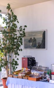 a kitchen with a table with a picture on the wall at Hotel Bellavista in Anacapri