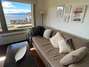 a living room with a couch and a large window at Quinta Luna in San Carlos de Bariloche