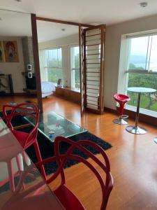 a living room with a glass table and red chairs at Miraflores Frente al Mar in Lima