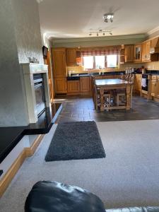 a kitchen with wooden cabinets and a table in it at Gallagh Guest House self catering h18r252 Eircode in Monaghan