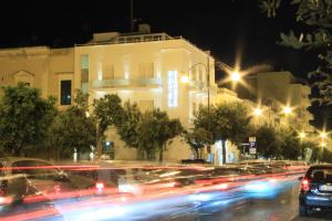a city street at night with cars and buildings at Hotel Città Bella in Gallipoli