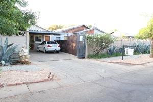 a house with a car parked in a driveway at The Hancock Inn in Klerksdorp