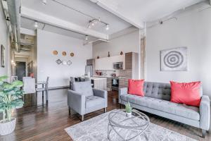 a living room with a couch and a table at Luxury Downtown Dallas Stay by Amyfinehouse in Dallas