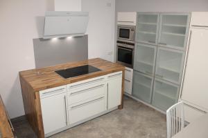 a kitchen with white cabinets and a sink at Apartment Hanske in Isenbüttel