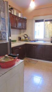 a kitchen with wooden cabinets and a refrigerator at Bed and breakfast in Ifrane