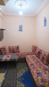 a living room with two couches and a rug at Bed and breakfast in Ifrane