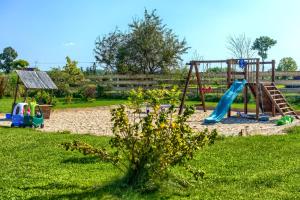 a park with a playground with a slide at Pod Mazurskim Niebem boho in Piecki