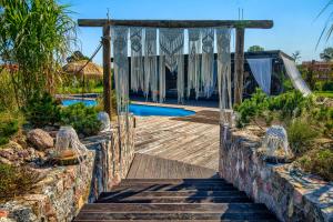 an entrance to a resort with a swimming pool at Pod Mazurskim Niebem boho in Piecki