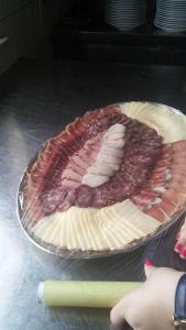 a pie with ham and cheese in a pie pan at apartma fortuna kmečki hram in Idrija