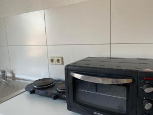 a microwave oven sitting on a counter in a kitchen at NEW beautiful place in the village near Leipzig in Elsteraue
