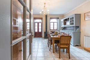a dining room with a table and chairs at Praça Guest House in Arouca