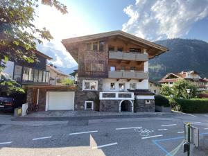 a large house with a garage in a parking lot at Haus Wierer in Mayrhofen