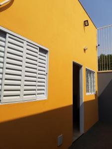 um edifício amarelo com uma janela e uma porta em Pelourinho em Olímpia