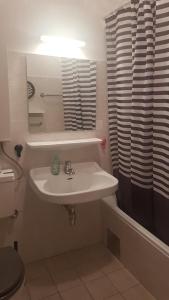 a bathroom with a white sink and a shower at Appartement Ferienregion Bad Gastein in Bad Gastein