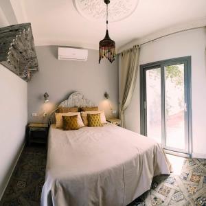 a bedroom with a bed and a large window at Ganesha.Beach apartment in Dahab