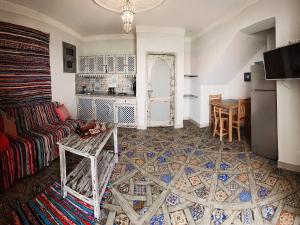 a living room with a couch and a table at Ganesha.Beach apartment in Dahab