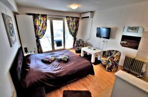 a small bedroom with a bed and a television at Fibos Studios in Ohrid