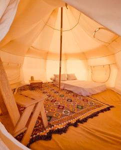 a room with a tent with a table in it at Al Nyhaya in Siwa