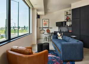 a living room filled with furniture and a window at The Catbird Hotel in RINO in Denver